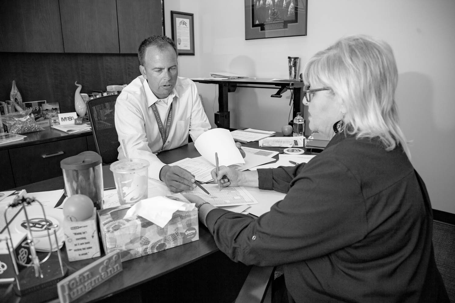 ON THE GO: Jungmann meets with Kathy Looten for upcoming travel plans. He has two work trips in July after he returns from a family vacation.